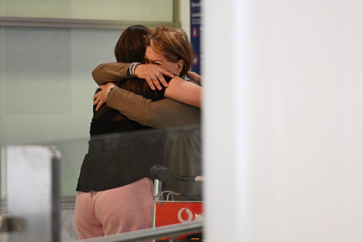 Symbolbild. Familie umarmt sich am Flughafen.